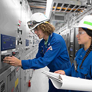 Two refinery engineers examining a facility